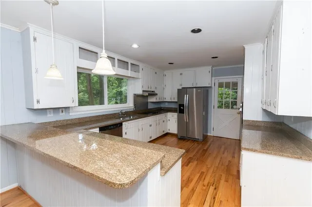 a view of a room with wooden floor and window