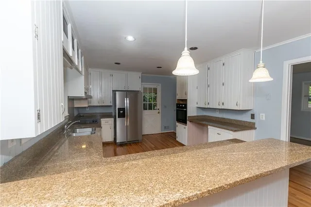 a bedroom with a bed and painting on the wall