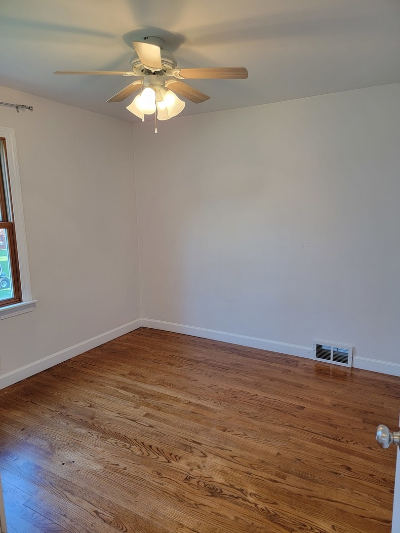 508 Skyline Drive Fox River Grove, IL 60021 - Photo 11 of 24 a view of a room with wooden floor and a ceiling fan