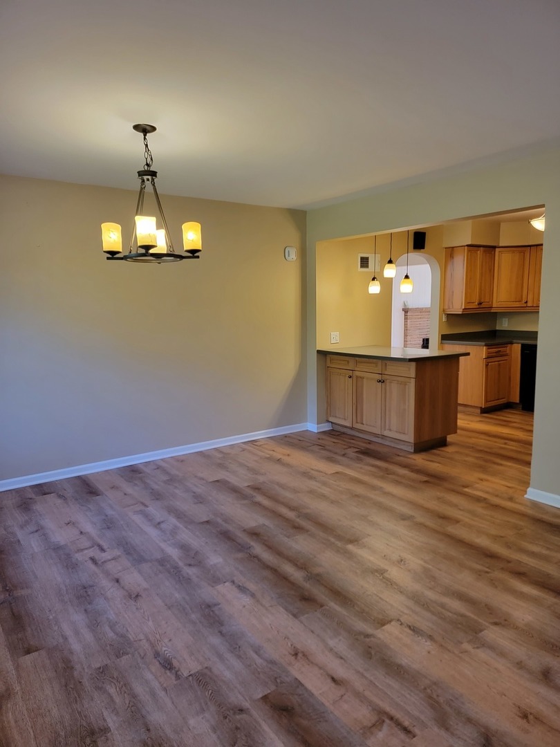 508 Skyline Drive Fox River Grove, IL 60021 - Photo 15 of 24 a room with a fireplace and wooden floor