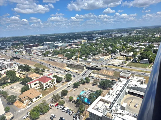 a dining room with furniture and a floor to ceiling window