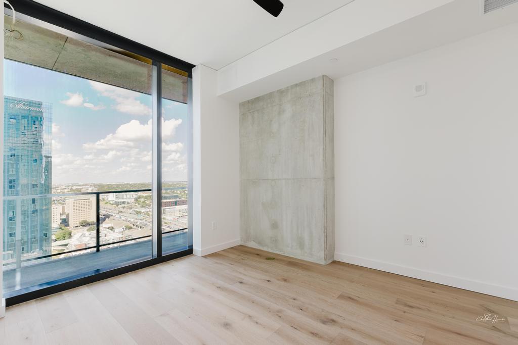 610 Davis Street, Unit 2608 Austin, TX 78701 - Photo 3 of 39 an empty room with sliding door and mountain view