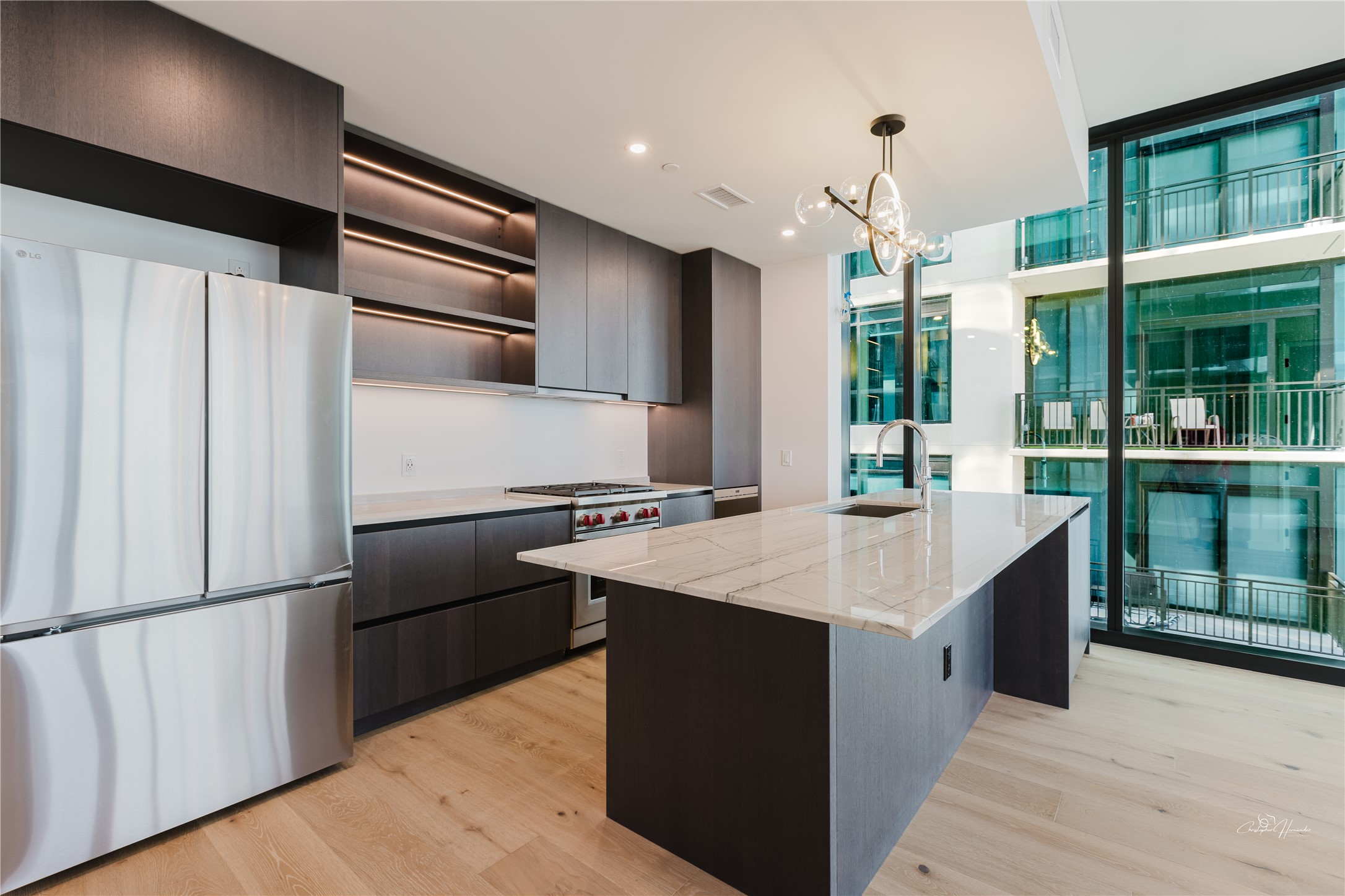 610 Davis Street, Unit 2608 Austin, TX 78701 - Photo 8 of 39 a kitchen with kitchen island a counter top space cabinets and stainless steel appliances
