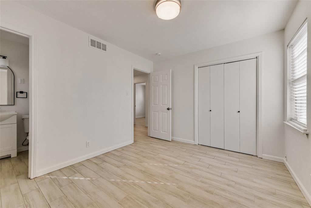 413 Simmons Drive Hurst, TX 76053 - Photo 16 of 26 a view of empty room with wooden floor and fan