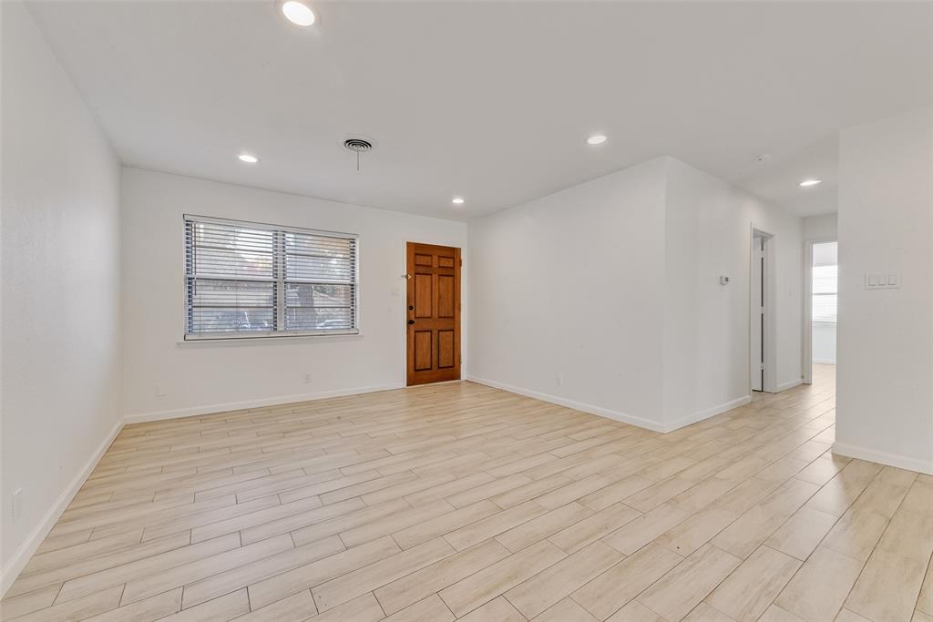 413 Simmons Drive Hurst, TX 76053 - Photo 25 of 26 an empty room with wooden floor and windows