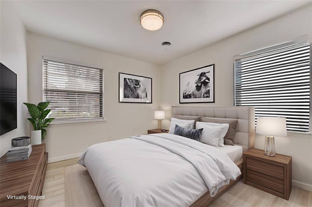 413 Simmons Drive Hurst, TX 76053 - Photo 10 of 26 a bedroom with a large bed and a potted plant