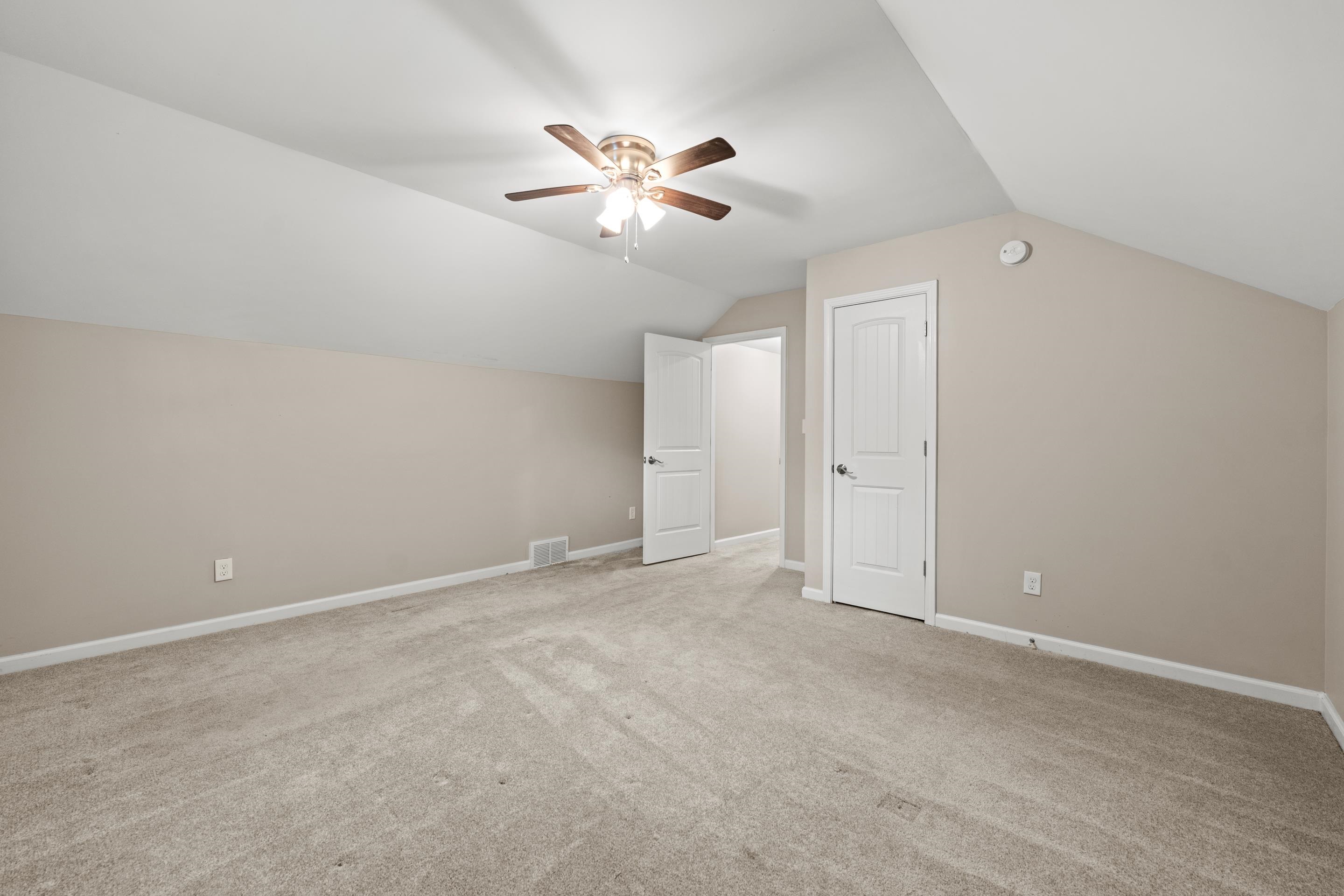 1255 Colonial Road Memphis, TN 38117 - Photo 25 of 30 Carpeted room featuring a ceiling fan with integrated lighting, white trim work, and two paneled doors with brushed nickel hardware