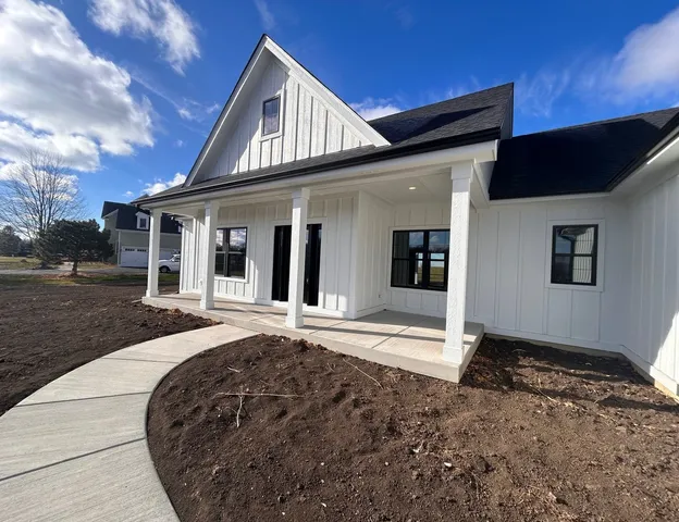 a front view of a house with a garden