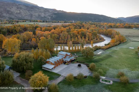 an aerial view of a house with a yard basket ball court and outdoor seating
