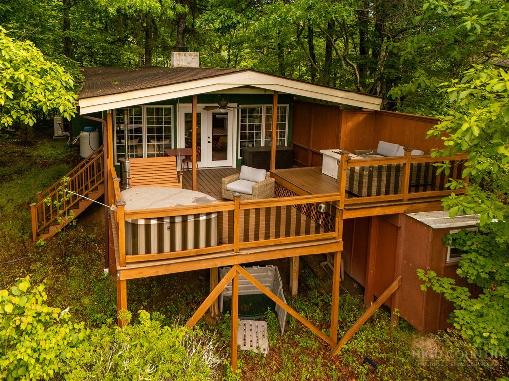 280 Chinkapin Ridge Road Seven Devils, NC 28604 - Photo 1 of 40 a view of a house with backyard and deck