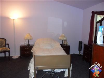 3248 Shale Road Palmdale, CA 93550 - Photo 11 of 19 a bedroom with a bed and a chandelier