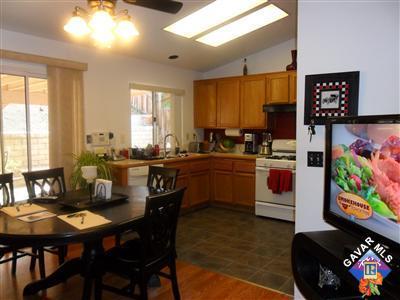 3248 Shale Road Palmdale, CA 93550 - Photo 5 of 19 a kitchen with sink a table and chairs