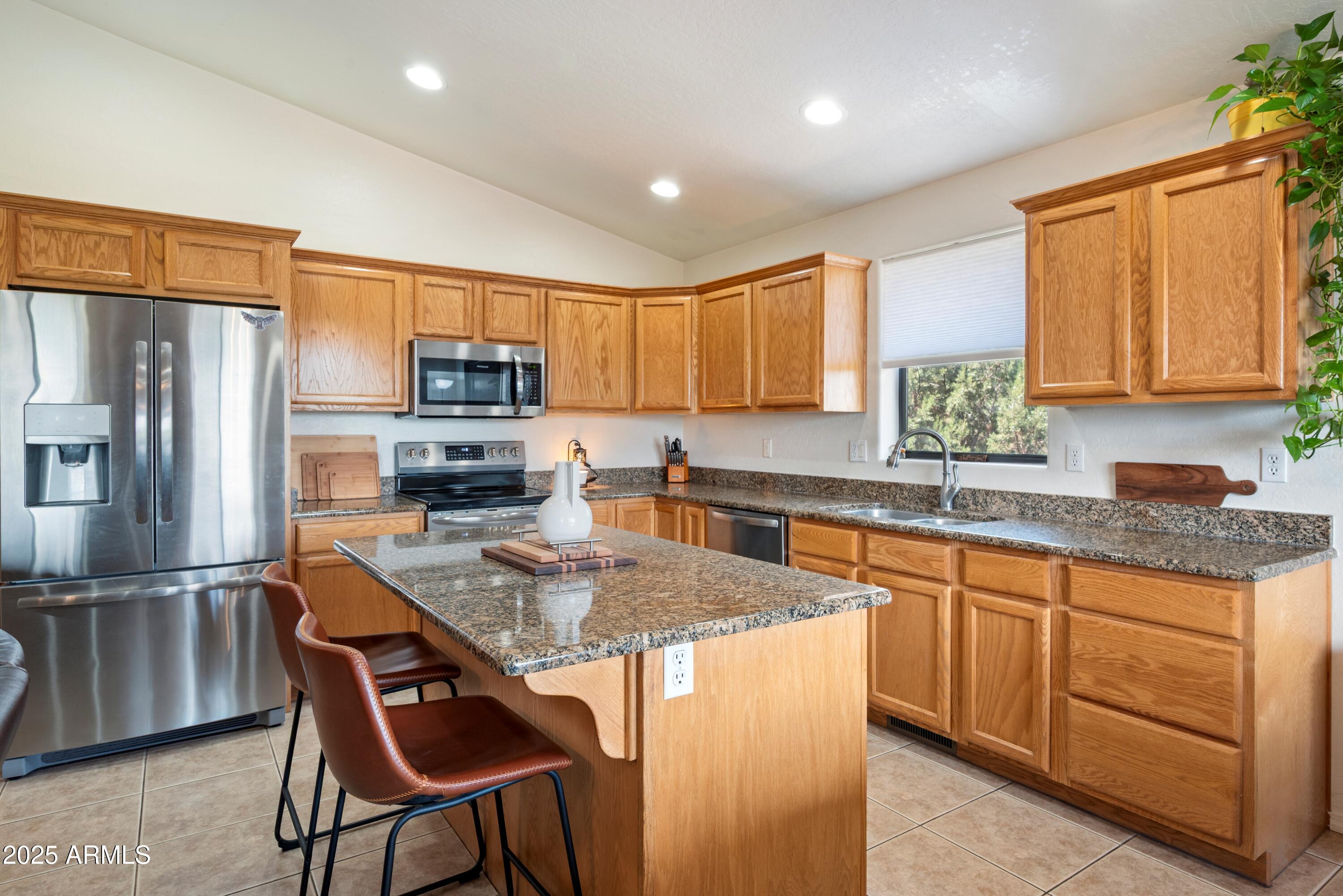 814 West Rim View Road Payson, AZ 85541 - Photo 11 of 42 a kitchen with stainless steel appliances granite countertop a stove a sink a microwave a refrigerator and cabinets