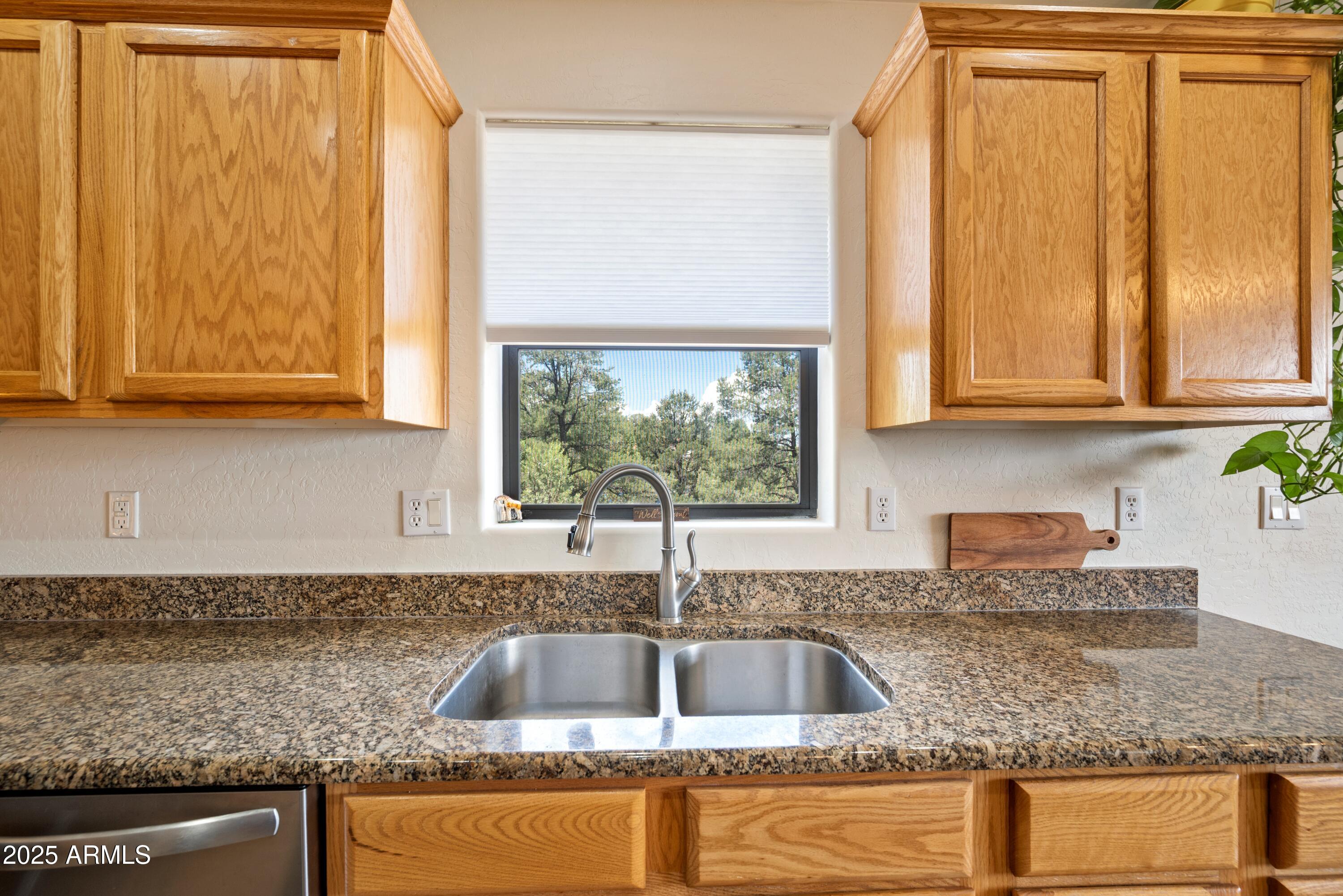 814 West Rim View Road Payson, AZ 85541 - Photo 14 of 42 a kitchen with granite countertop a sink window and cabinets