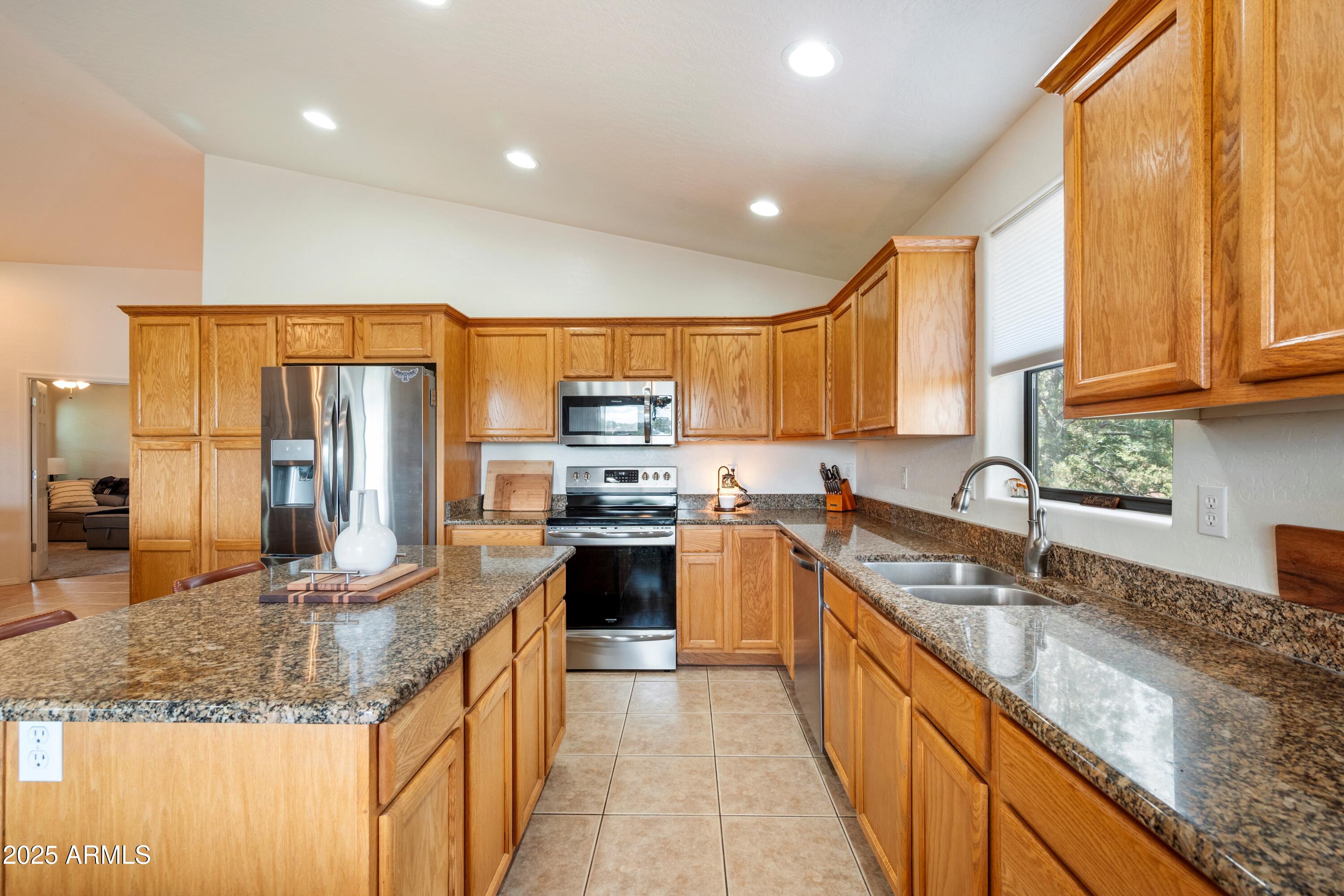 814 West Rim View Road Payson, AZ 85541 - Photo 15 of 42 a large kitchen with stainless steel appliances granite countertop a sink stove and refrigerator