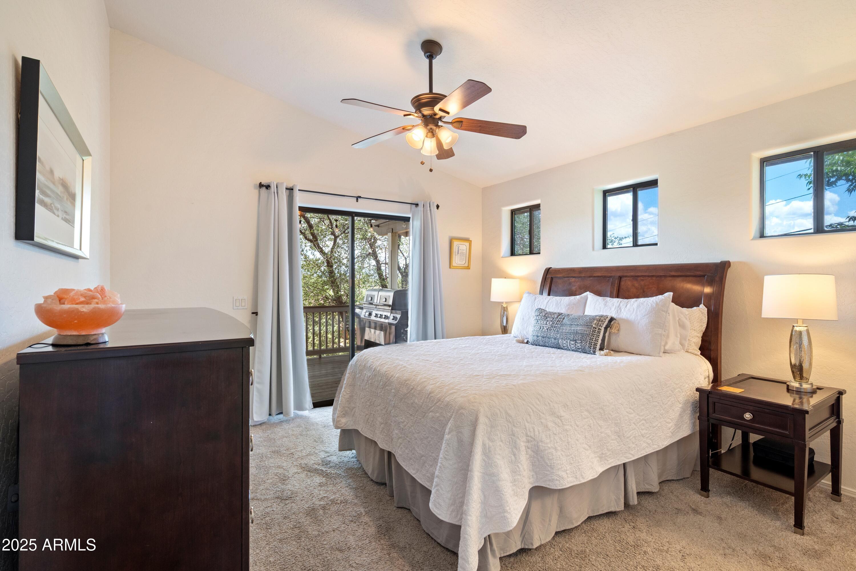 814 West Rim View Road Payson, AZ 85541 - Photo 19 of 42 a bedroom with a bed and a chandelier