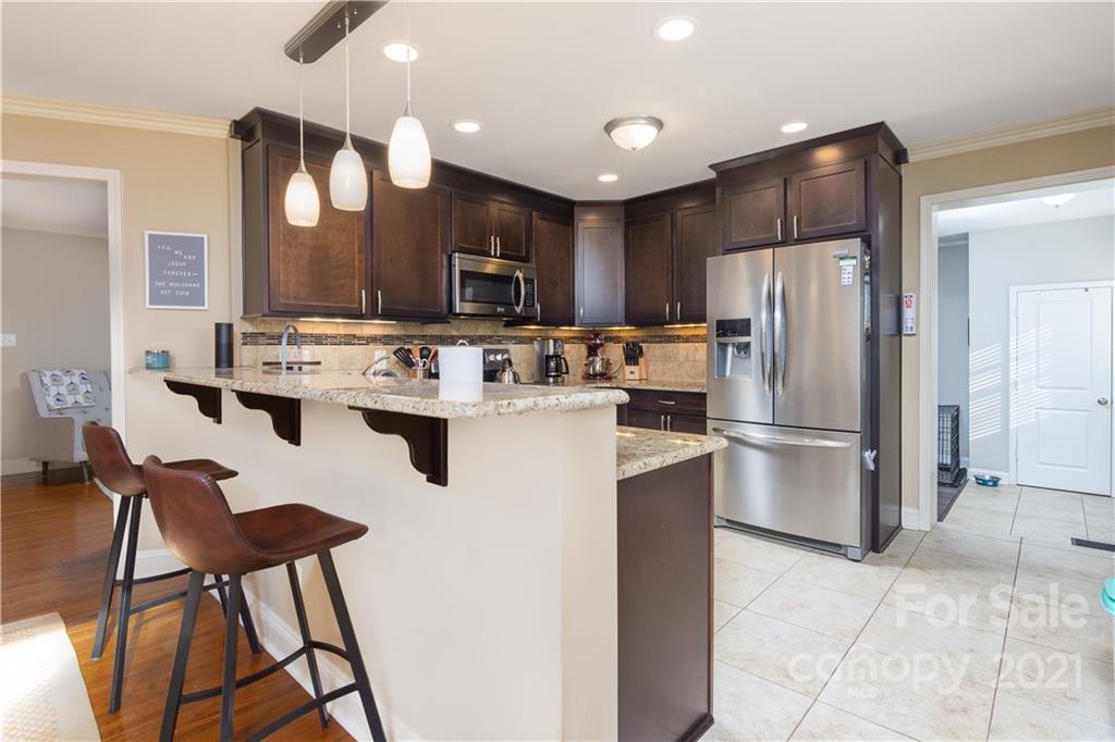 5201 Londonderry Road Charlotte, NC 28210 - Photo 14 of 42 a kitchen with stainless steel appliances a refrigerator a stove a sink and a chairs