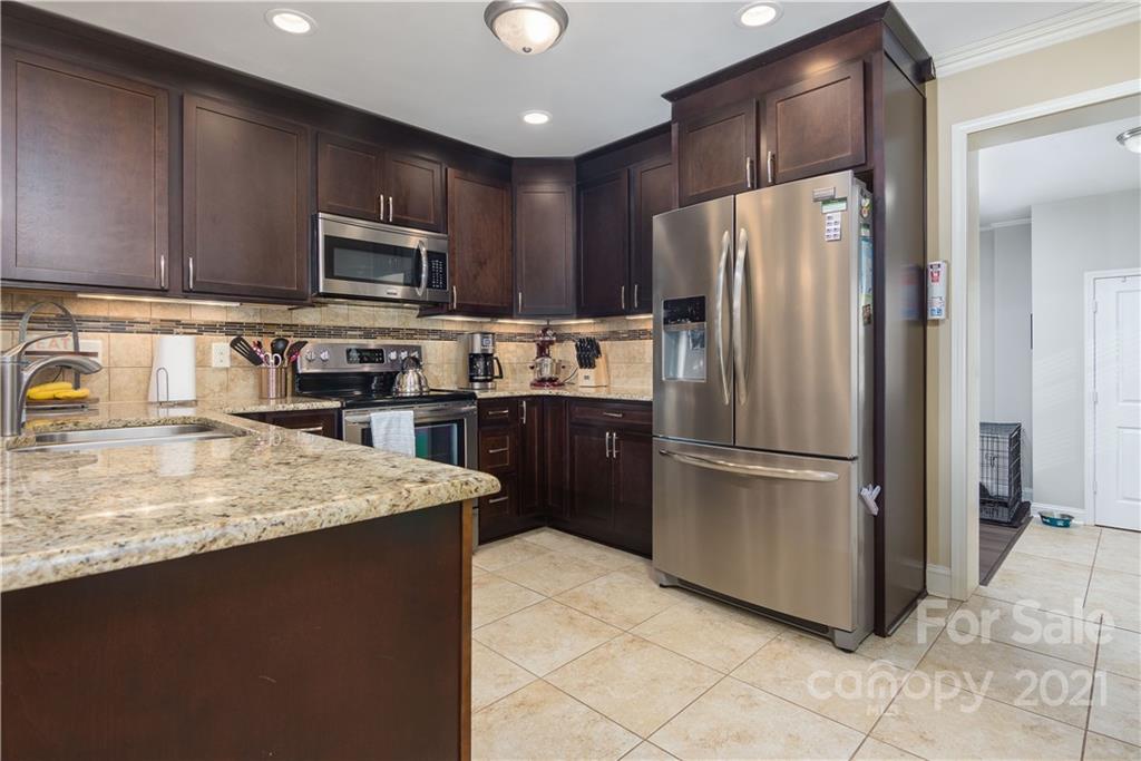 5201 Londonderry Road Charlotte, NC 28210 - Photo 15 of 42 a kitchen with stainless steel appliances granite countertop a refrigerator stove microwave and sink