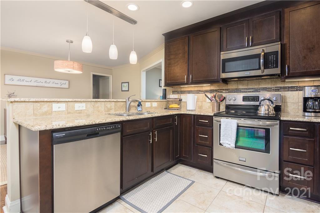 5201 Londonderry Road Charlotte, NC 28210 - Photo 16 of 42 a kitchen with stainless steel appliances granite countertop a sink and a stove