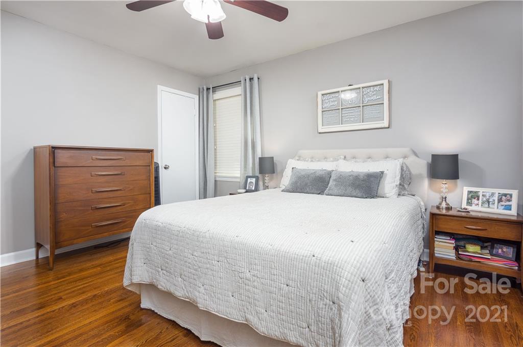 5201 Londonderry Road Charlotte, NC 28210 - Photo 28 of 42 a bedroom with a bed and wooden floor