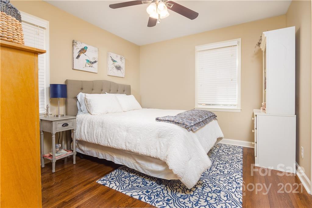 5201 Londonderry Road Charlotte, NC 28210 - Photo 31 of 42 a bedroom with a bed and a chandelier