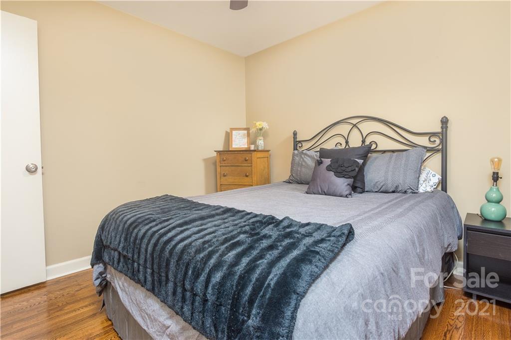 5201 Londonderry Road Charlotte, NC 28210 - Photo 34 of 42 a bedroom with a bed and wooden floor