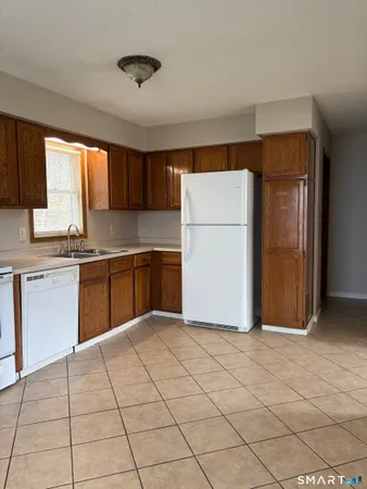 a kitchen with stainless steel appliances granite countertop a refrigerator sink and cabinets