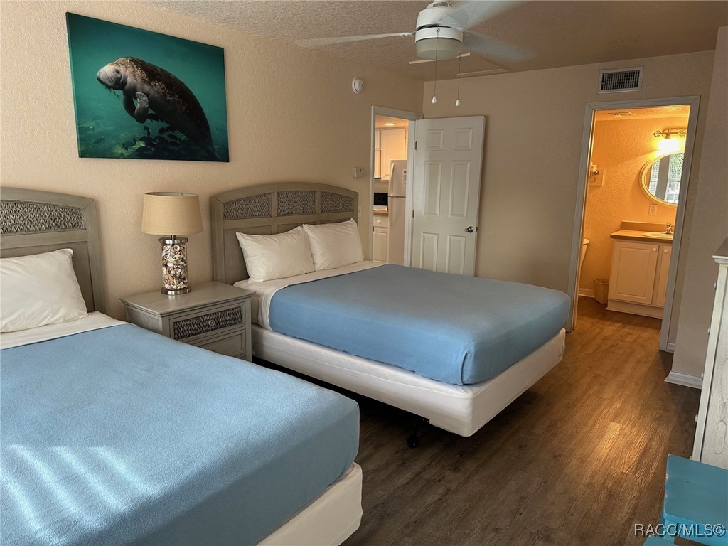 5291 South Cherokee Way Homosassa, FL 34448 - Photo 16 of 27 a bedroom with two beds and wooden floor