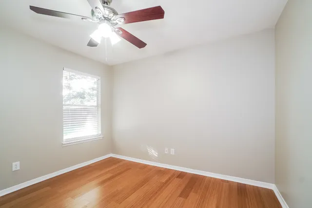 wooden floor in an empty room with a window