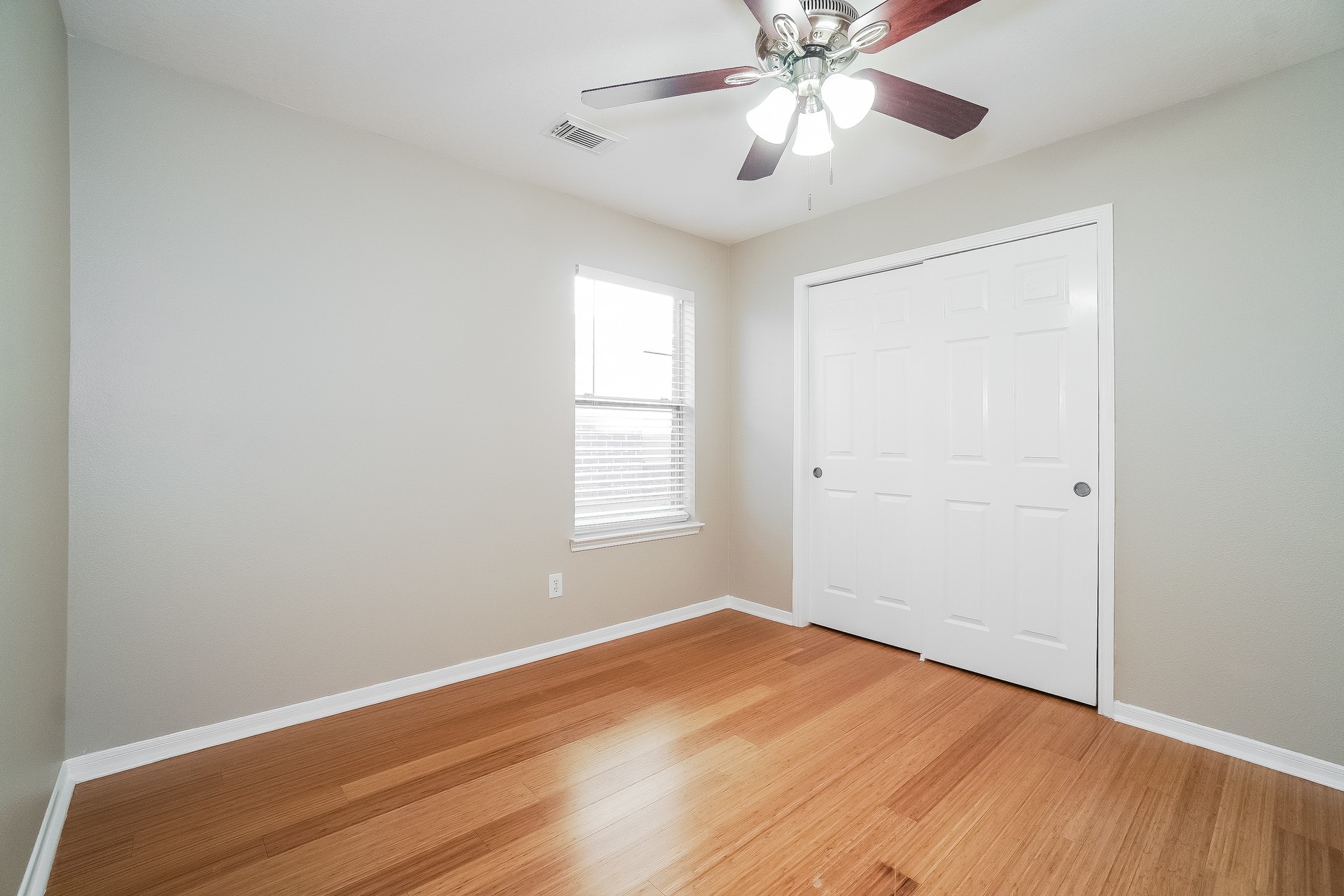 24223 Camillia Ridge Way Katy, TX 77493 - Photo 14 of 16 wooden floor in an empty room with a window