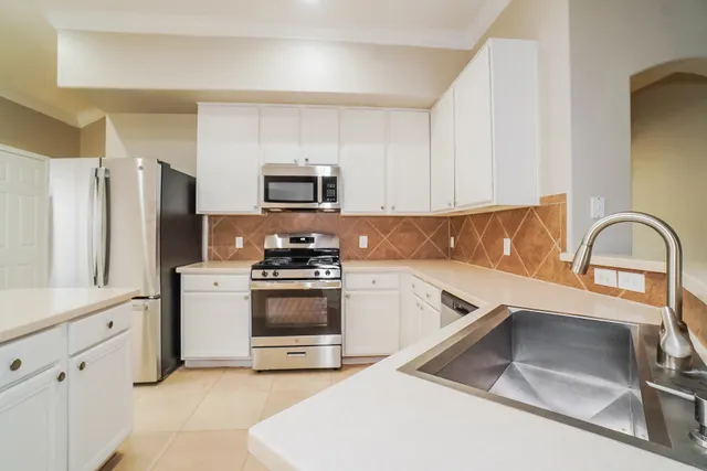 a kitchen with a refrigerator stove and sink