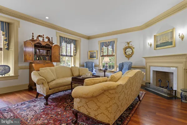 a living room with a fireplace and a mirror