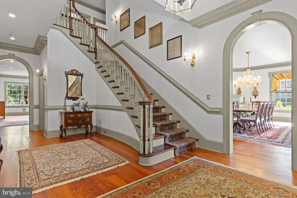 a view of a dining room with furniture wooden floor and chandelier