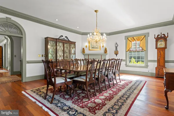 a view of a a dining room with furniture window and wooden floor