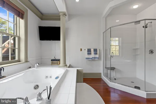 a spacious bedroom with a bed and glass window