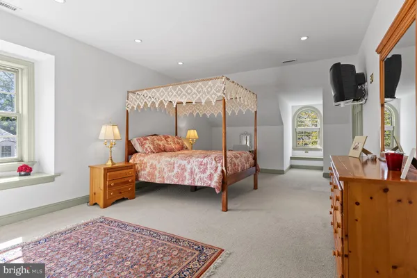 a living room with furniture a fireplace and a chandelier