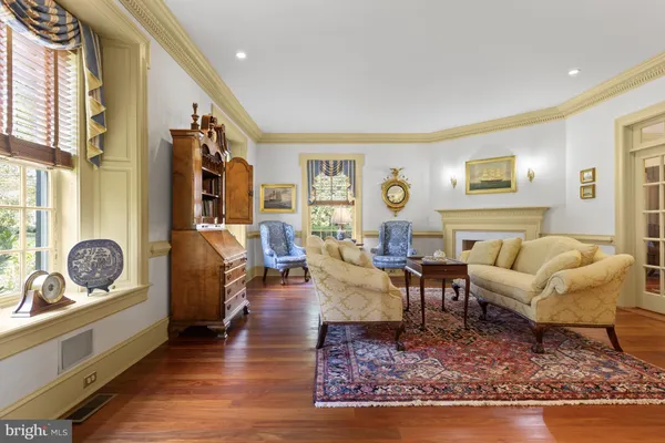 a living room with furniture a fireplace and a window