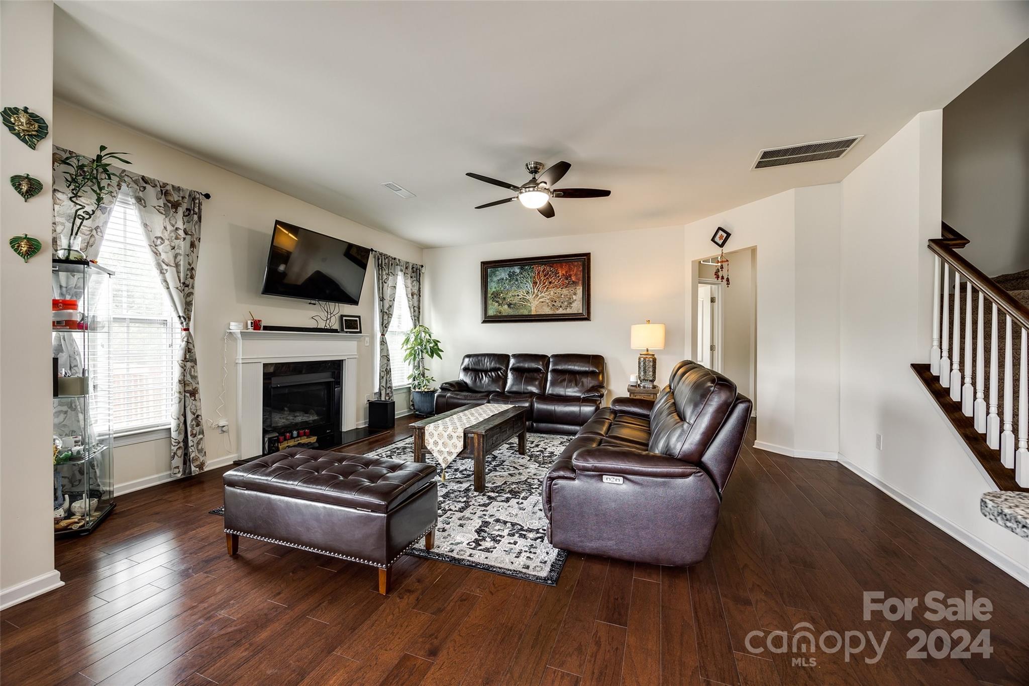 819 Bridge View Court Fort Mill, SC 29708 - Photo 12 of 40 a living room with furniture a flat screen tv and a fireplace