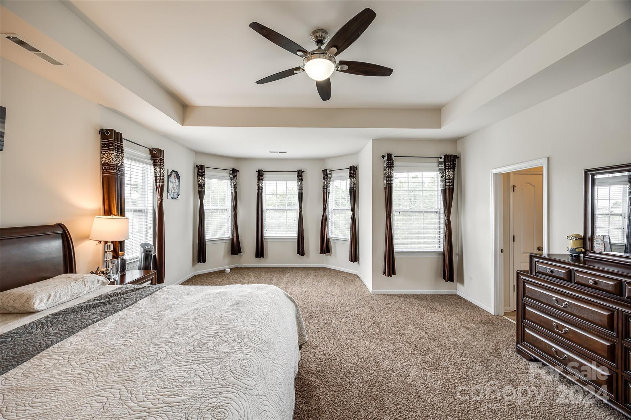 819 Bridge View Court Fort Mill, SC 29708 - Photo 17 of 40 a spacious bedroom with a large bed and a chandelier