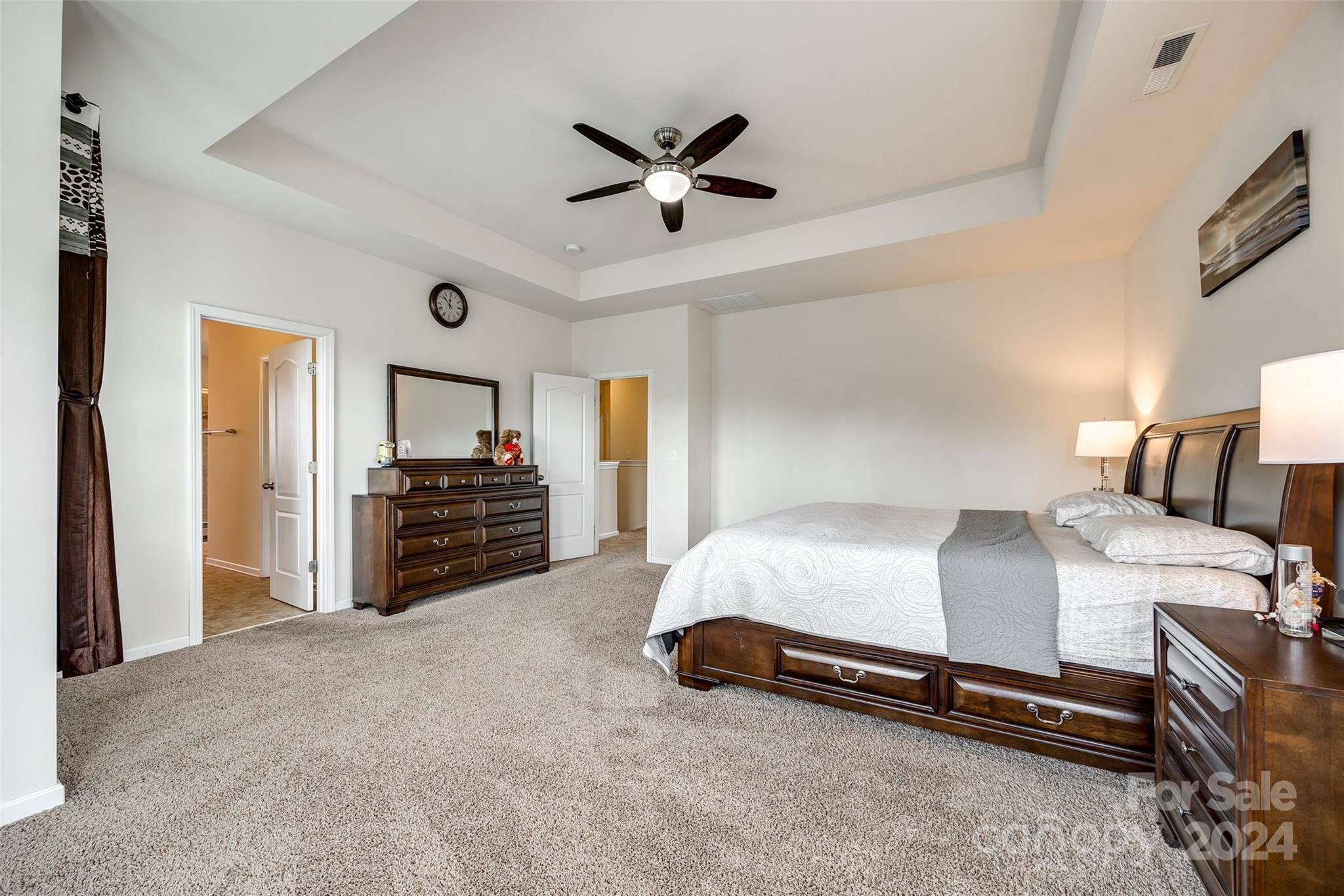819 Bridge View Court Fort Mill, SC 29708 - Photo 19 of 40 a spacious bedroom with a bed and a ceiling fan