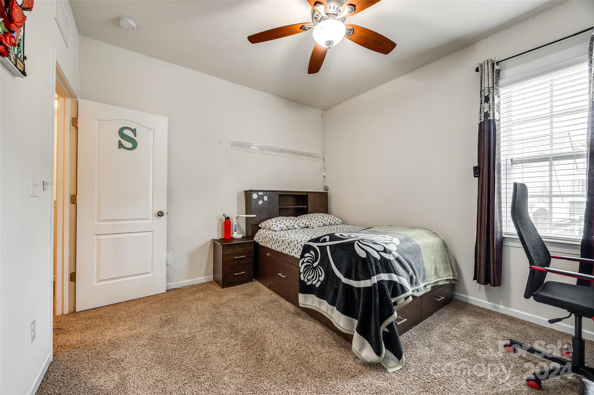 819 Bridge View Court Fort Mill, SC 29708 - Photo 29 of 40 a bedroom with a bed and a chandelier