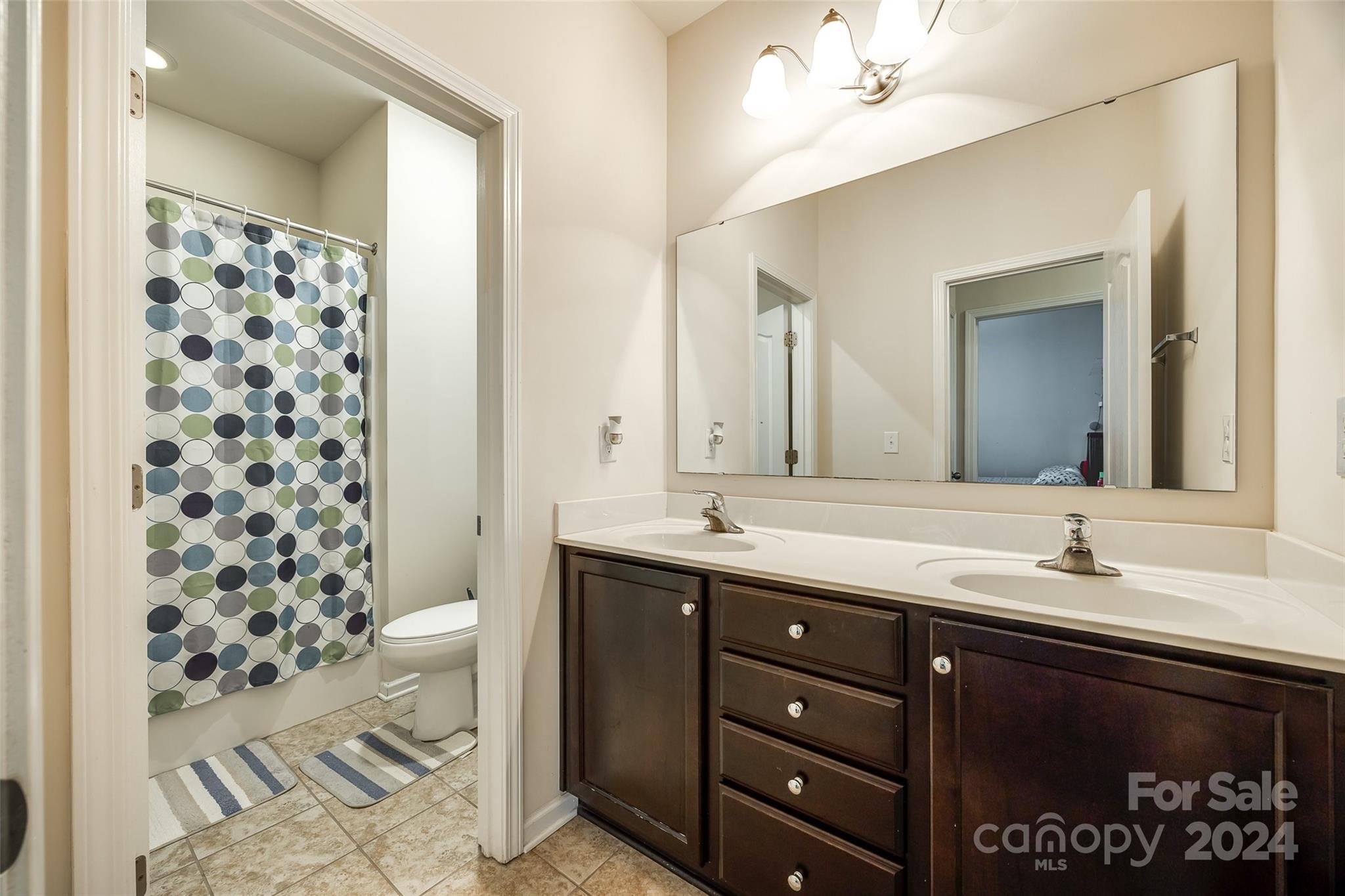 819 Bridge View Court Fort Mill, SC 29708 - Photo 30 of 40 a bathroom with a sink double vanity and a shower