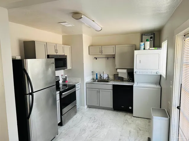 a kitchen with a refrigerator and a sink