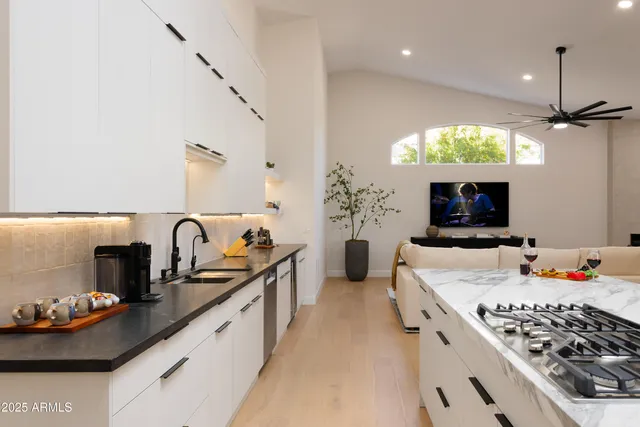 a kitchen with stove a sink and a refrigerator