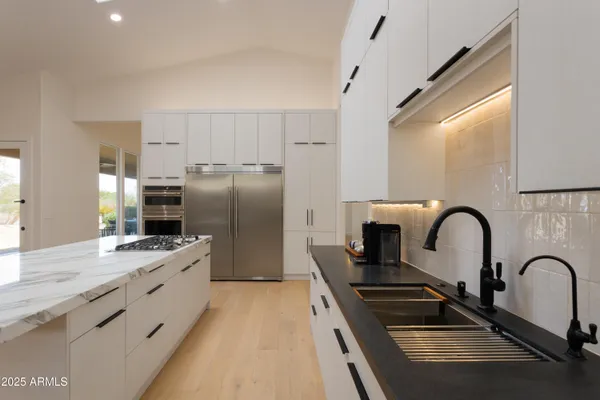 a kitchen with refrigerator a sink and cabinets