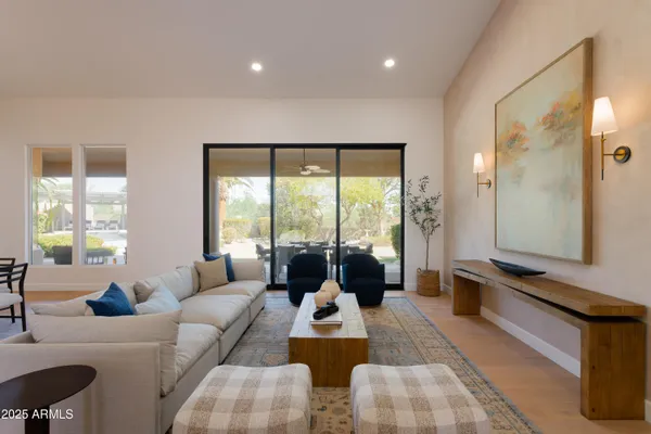 a living room with furniture and floor to ceiling windows