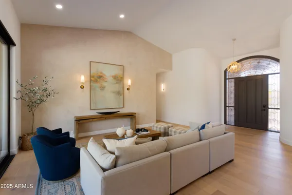 a living room with furniture and a chandelier