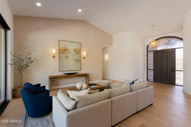 a living room with furniture and a chandelier