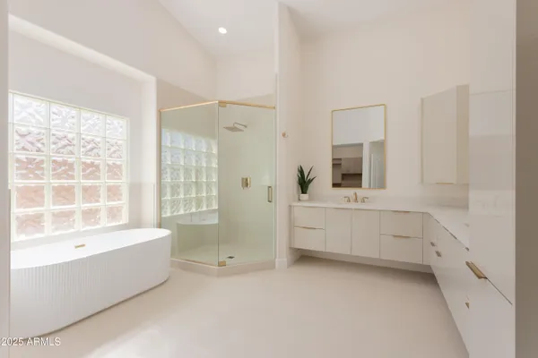 a bathroom with a bathtub sink and mirror