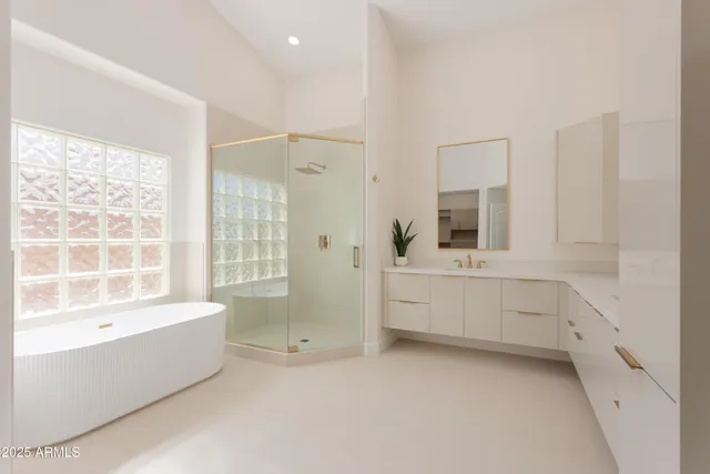 a bathroom with a bathtub sink and mirror